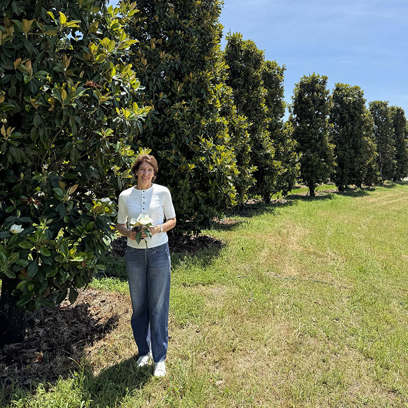 Julie Holding Magnolia Bloom in Grove