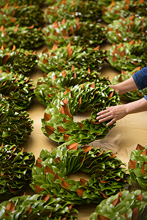 Hand-crafted magnolia wreaths on table